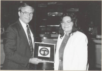 Photo of Harry Mitchell and Barbara Sherman with Framed City Seal, 1992.