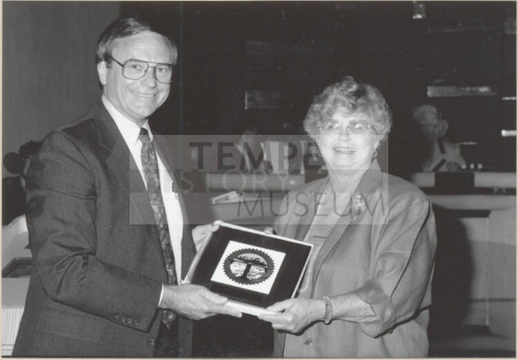 Photo of Harry Mitchell and Pat Hatton with City Seal, 1992.