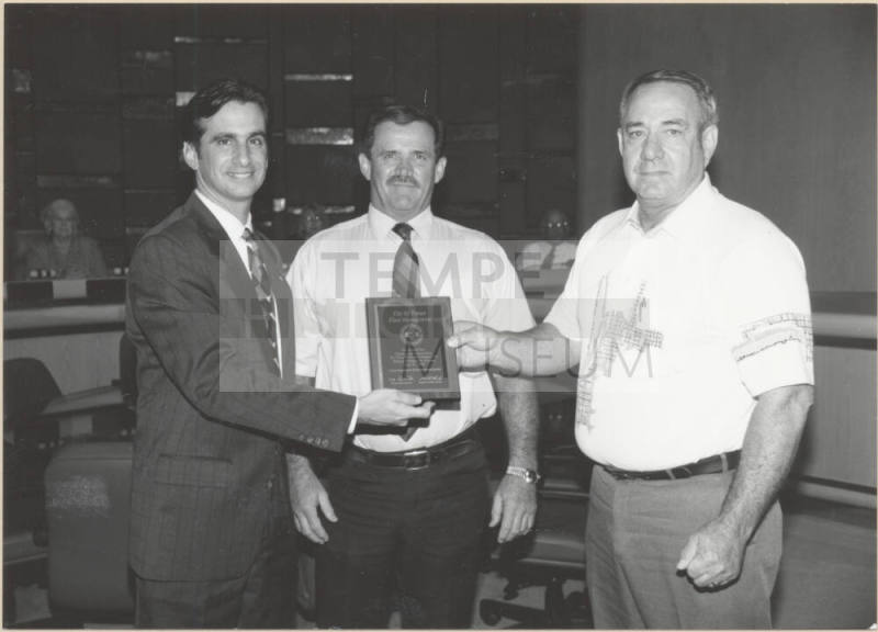 Neil Giuliano Receiving a Plaque Acknowledging Tempe Fleet Services for Reducing Pollution.