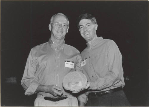Photo of Hugh Hallman Presenting Plaque to Bob Gasser, 1999.