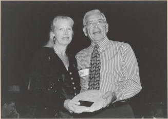 Photo of Joe Spracale Presenting Outgoing Member Plaque to a Woman at Boards and Commissions, 1999.