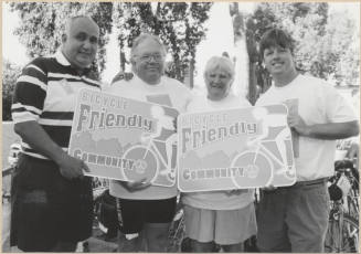 Ben Arredondo, Lonnie Fredericks, Monica Kast and Joseph Lewis with "Bicycle Friendly Community" Signs.
