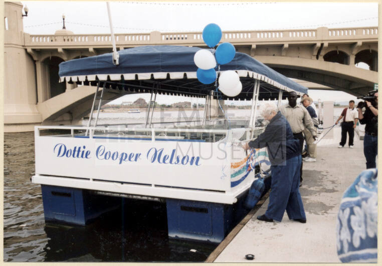 Photo of christening of the Dottie Cooper Nelson boat on Tempe Town Lake.