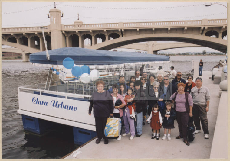 Photo of Clara Urbano, family and friends next to Clara Urbano Boat on Tempe Town Lake.