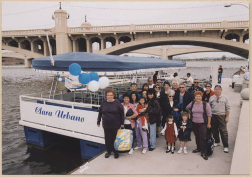 Photo of Clara Urbano, family and friends next to Clara Urbano Boat on Tempe Town Lake.