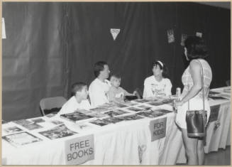 Photo of Stand for Children event - free books for kids table.