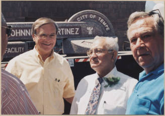 Photo of water treatment plant dedication to Johnny Martinez in which he stands with two men.  The man to his right is Harry Mitchell.
