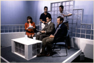 Color photograph of Niel Giuliano and others preparing to appear on local television