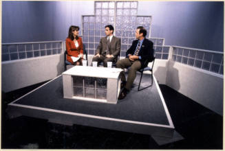 Color photograph of Niel Giuliano and others appearing on local television