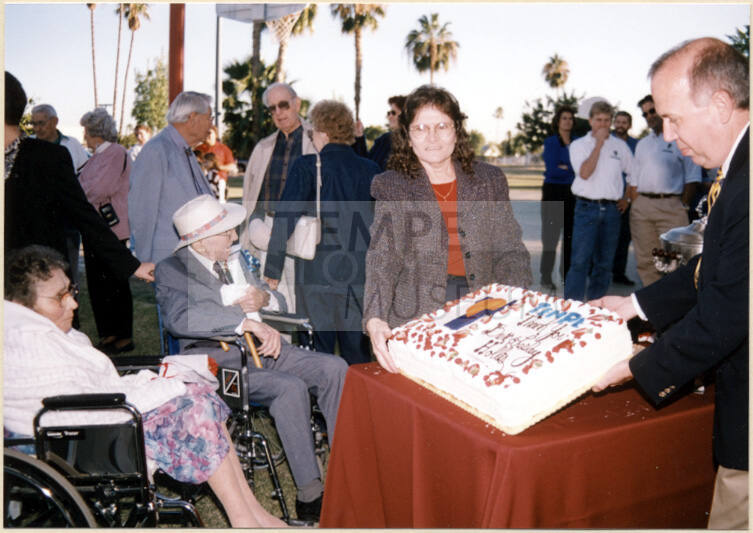 Color photograph of cake presentation at Hollis Family Park dedication
