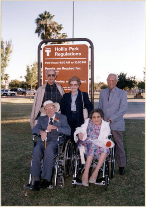 Color photograph of Bud and Leslie Hollis with three unknown persons standing by Hollis Park rules sign at dedication