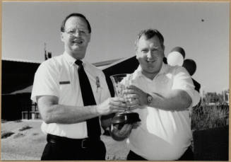 Black and white photograph of Cliff Jones and unknown man at dedication of Apache Blvd. Fire Station