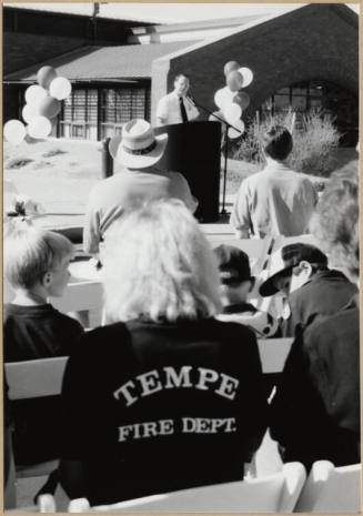 Black and white photograph of Fire Chief Jones speaking to a crowd at the dedication of Apache Blvd. Fire Station