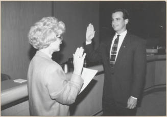 Black and white photograph of Mayor Niel Giuliano being sworn in by City Clerk Helen Fowler