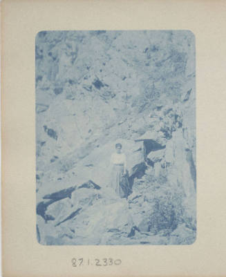 Unidentified Woman Standing by Rocks