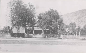 Photograph, house with butte in the background