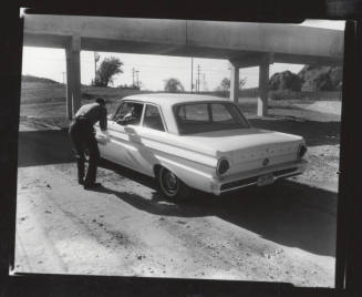 AFL-CIO organizer talking to another man in a Ford Falcon car