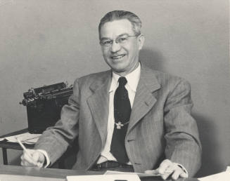 Photograph of Harvey Harelson at Desk