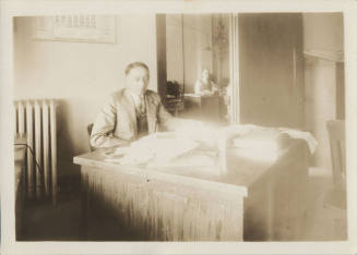 Charles Martin Senior Seated at Desk