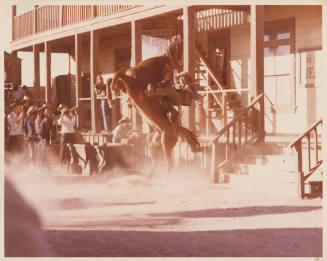 Sepia Photo of Larry Finley on a rearing horse on a western set