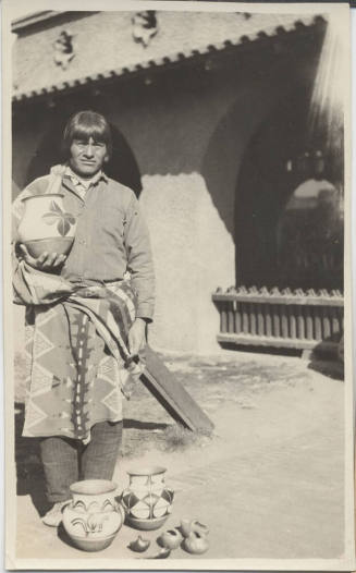 Native American Man Holding Pottery
