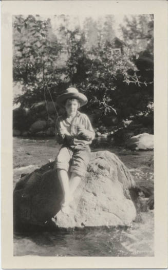 Young Person Fishing from Rock in Stream