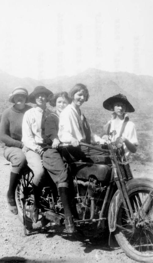 Women posed on Harley Davidson Motorcycle while on a Tempe High School field trip