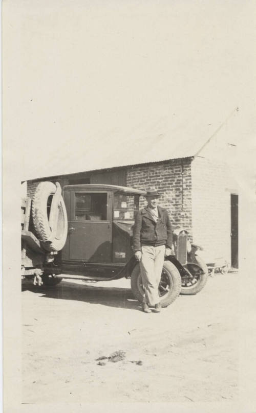 Harry Hendricks Standing Beside Truck