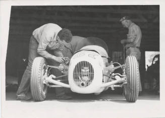 Three Mechanics with Racing Car