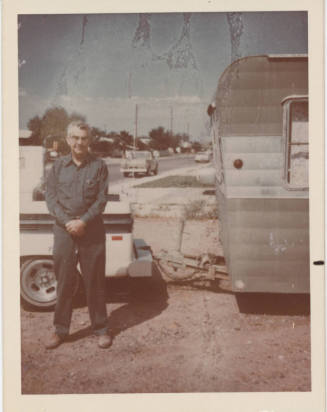 Man Standing Beside Truck with Trailer