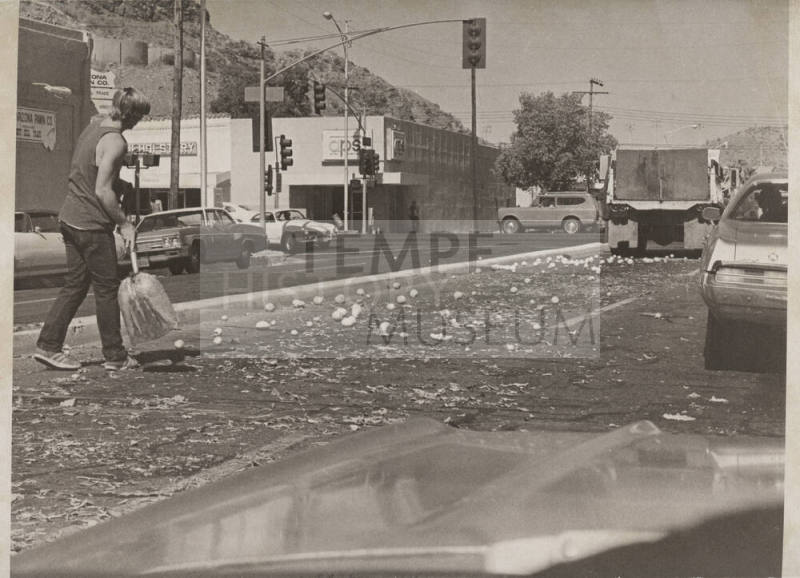 Man Cleaning Up Oranges-5th St and Mill