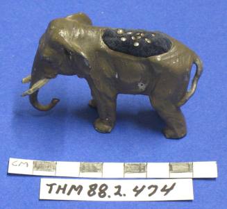 Elephant figurine with a pincushion on the top of the back