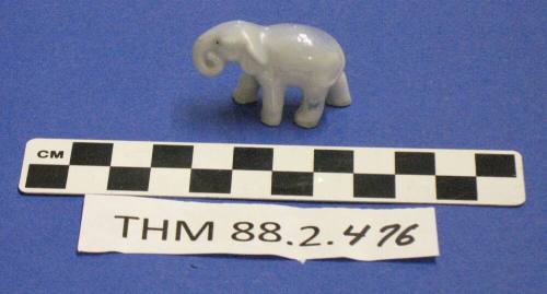 Blue grey elephant figurine with a curled trunk