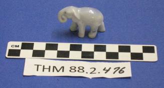Blue grey elephant figurine with a curled trunk