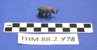 Miniature standing grey elephant figurine with pink ears.