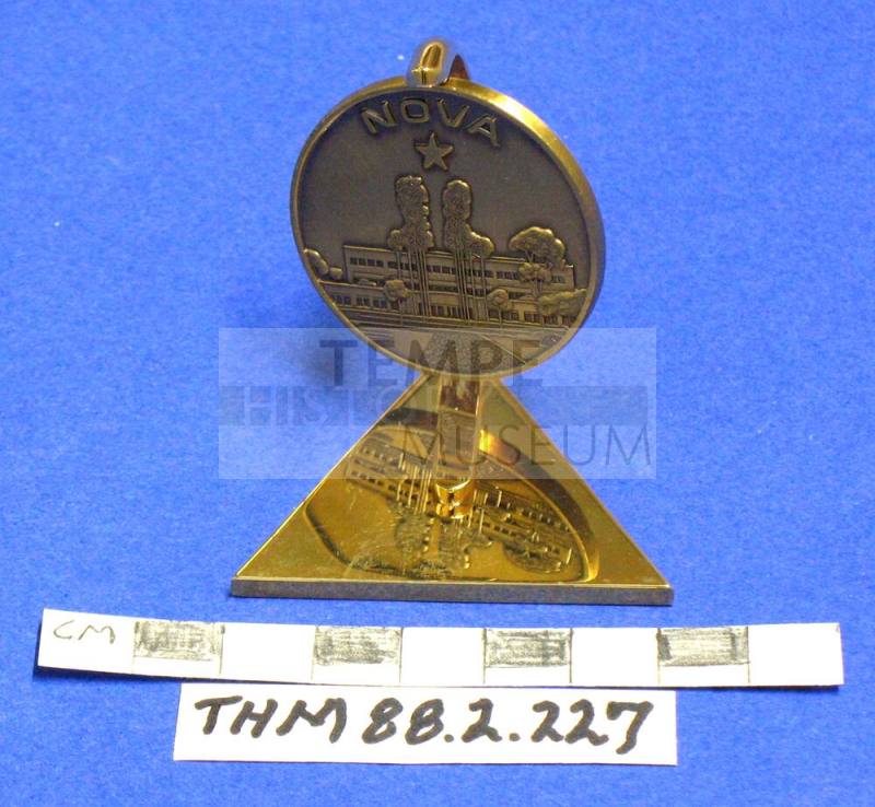 Paperweight of brass with a revolving medallion: Nova, St. Lukes Hospital, 1987