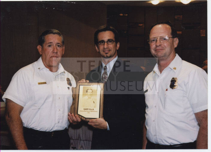 Photograph of Mayor Giuliano Presenting Gary Ells with Arizona Fire Service Hall of Fame Plaque, 2002