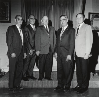 Five men in coats and ties