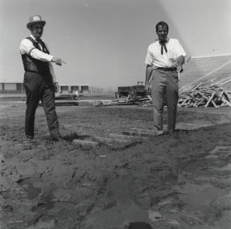 Men Standing In A Field - Bleachers