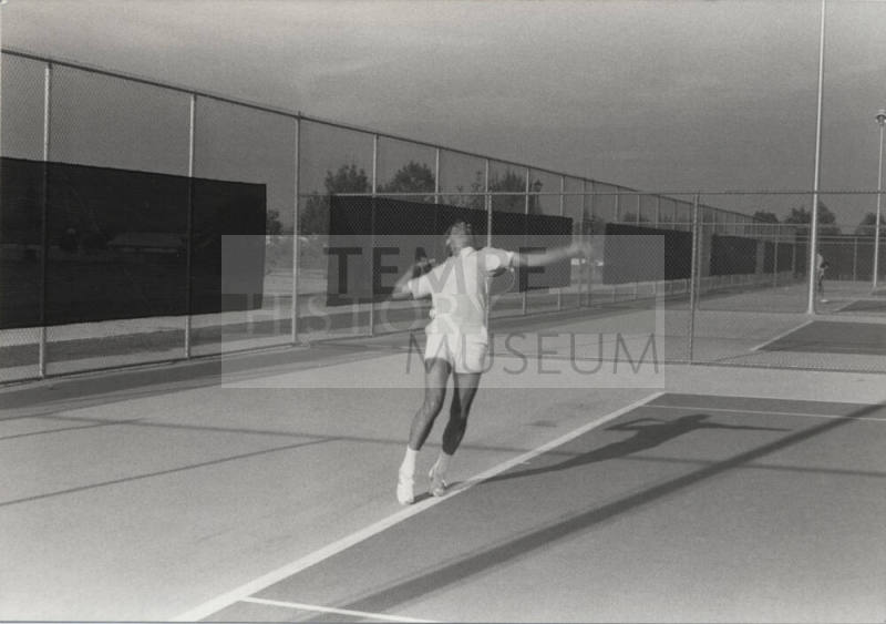 Unidentified Man Playing Tennis at Kiwanis Recreation Center in Kiwanis Park
