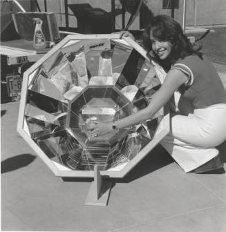 Mary Laguna demonstrates a Solar Oven