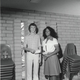 Two Unidentified Teenagers Holding Checks