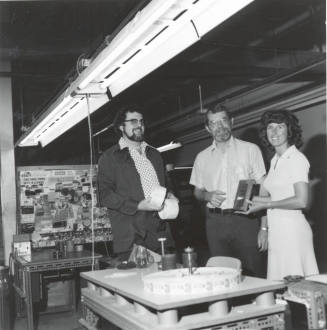 Marge McLaughlin and Two Unknown Men Displaying a Plaque