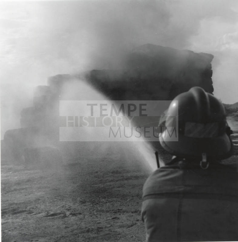 Firefighter Hoses Down a Hay Fire - Tempe Daily News, June 9, 1977