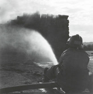 Firefighter Hoses Down a Hay Fire - Tempe Daily News, June 9, 1977