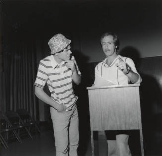 Two Men Standing At Podium