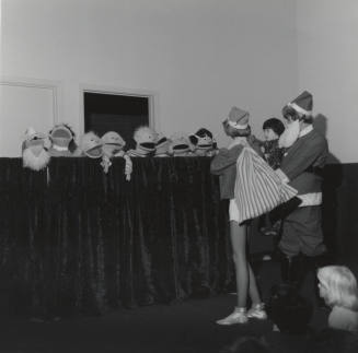 People In Costume And A Row Of Puppets