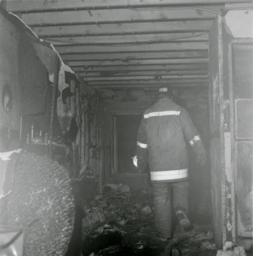Fireman in a burned-out structure, February 1978