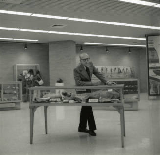 Professor with display case -- May 1978