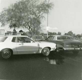 A Man And Woman Exit a White Car - September 1978